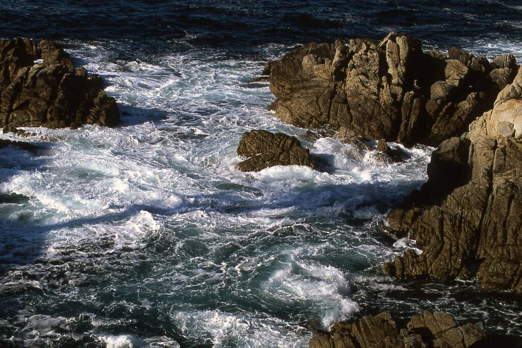 Waves crashing on rocky cliffs