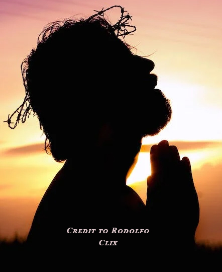 Silhouette of a person praying against a sunset sky. Silhouette of a person praying against a sunset sky.